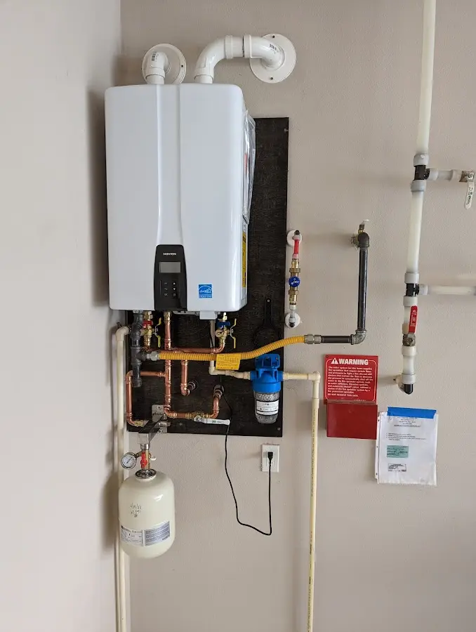 Professional plumber installing copper piping in a Doral home